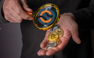 The magnifier with the Chainalysis logo is aimed at cryptocurrencies.
