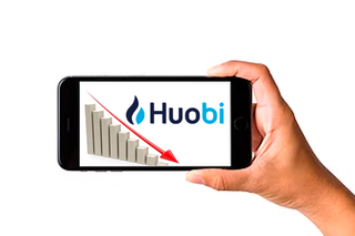 A phone with the Huobi logo and graph on the screen.